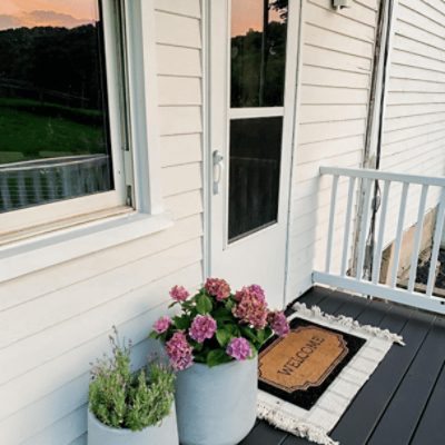 Porch painted in Aesthetic White SW 7035 by @emilygoodwinhome.
