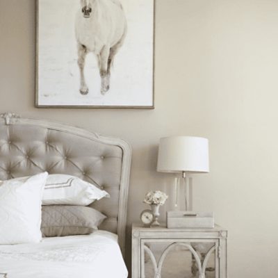 A bedroom painted in worldly gray sw 7043 by @shumanmabeunteriors.