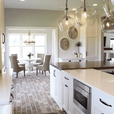 A kitchen painted in worldly gray sw 7043 by @styledbysorells.