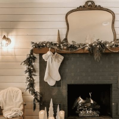 Indoor living room area with a dark green fireplace decorated for Christmas, by tracyzlock