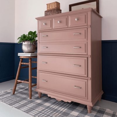 Bedroom with SW 9081 Redend Point painted dresser and navy blue and white walls. 