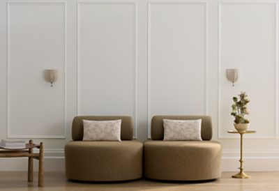 Two accent chairs against a bright wall.