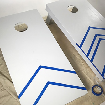 Drawing designs on two cornhole boards