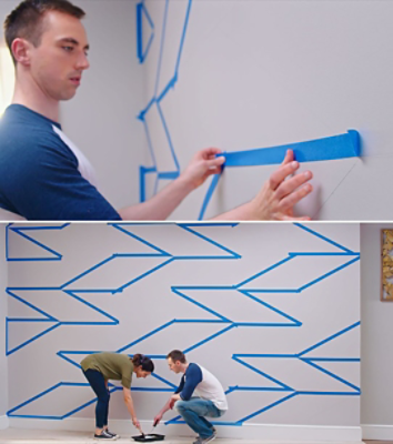 A man using masking tape for his wall designs.