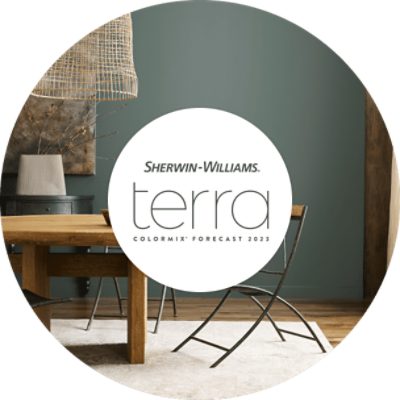 Sherwin-Williams Terra Colormix Forecast 2023 with a modern table and gray-green walls.