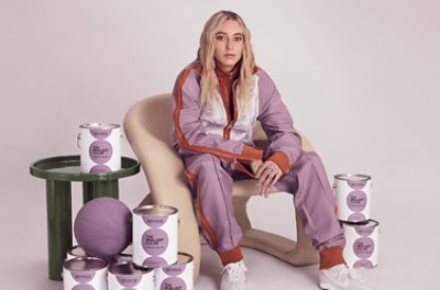 Image of Paige Bueckers with The Loneliest Color branded paint cans.