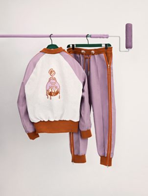A Loneliest Color branded track suit hanging on a roller pole.