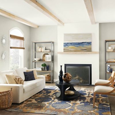 A white and cream painted room with neutral furniture.