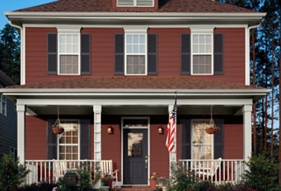 A traditional-style home with red paint and dark blue window shutters. S-W Colors featured: SW 7591, SW 7008, SW 6989