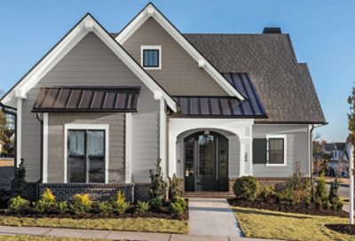A traditional-style home with neutral tone paint and dark brown roofing. S-W Colors featured: SW 7669, SW 7006, SW 6994