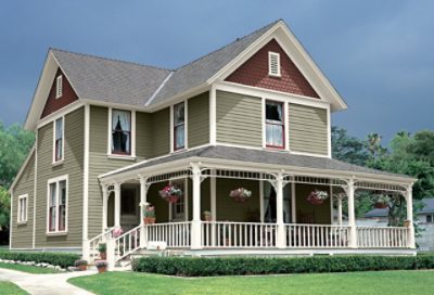 A traditional-style home with sage green paint and dark red roofing. S-W Colors featured: SW 7748, SW 6154, SW 6055