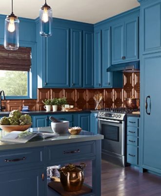 A grandeur blue painted kitchen with brown cabinets.