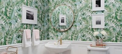 A tropical green wallpaper used in a bathroom