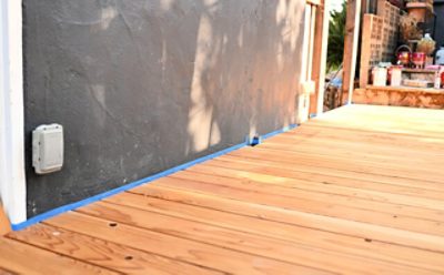A clean deck outlined with painter's tape prepared for staining.