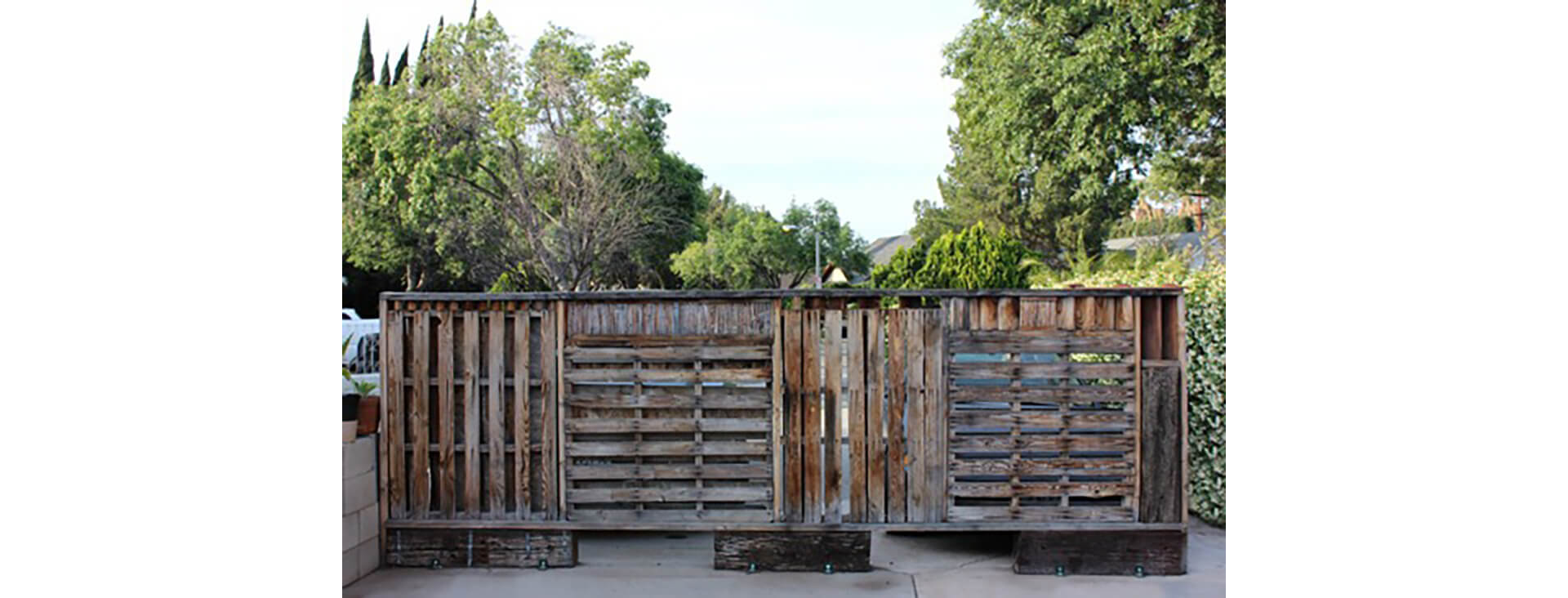 A dark, unstained outdoor pallet wall