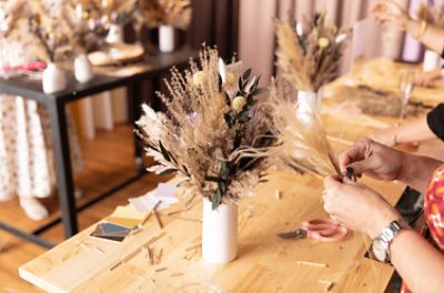 A person making a floral arrangement.