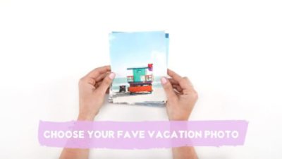 A woman holding a series of vacation photos for paint visualization. 
