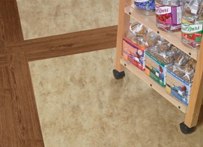 A snack cart on top of vinyl plank flooring.