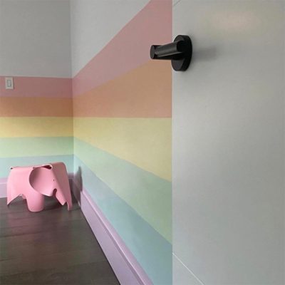 A nursery with pink walls and furniture