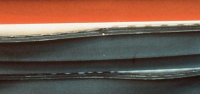A close-up of warped or buckled vinyl siding.