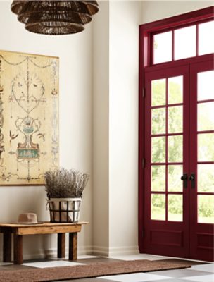 An entryway with walls painted Oyster White SW7637 and double doors and transom painted Borscht SW7578.