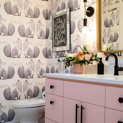 A bathroom with whimsical fox pattern wallpaper.