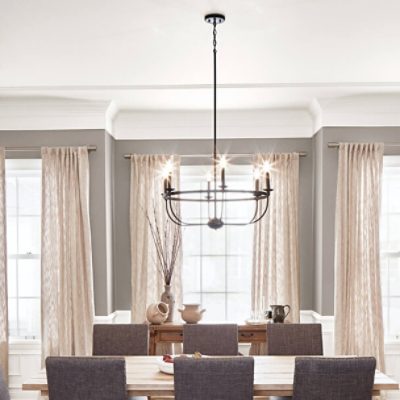 A formal dining room with gray walls and white trim.