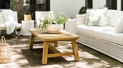 A wooden coffee table on a modern designed deck. 