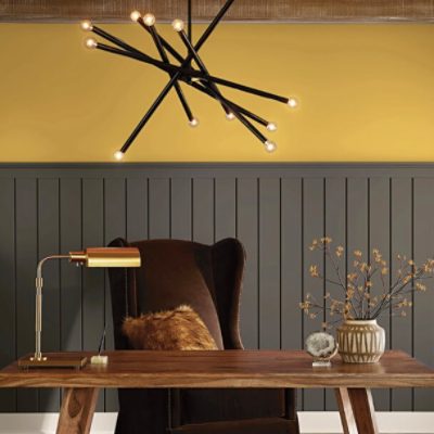A home office with the upper third of the wall painted yellow.