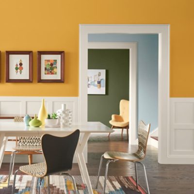 A kitchen eating area with the upper half of the wall painted yellow.