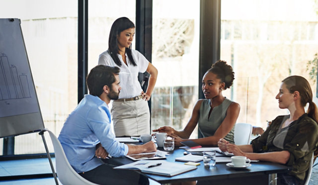 New team members in a modern office discussing business at a table