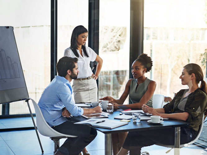 New team members in a modern office discussing business at a table